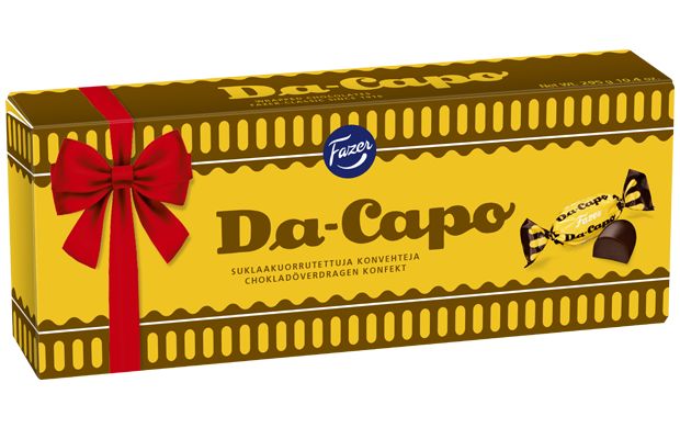 The yellow and brown Fazer Da Capo Praline box by Fazer features a red ribbon design, bilingual Finnish and Swedish text, and images of the wrapped chocolate rum truffle pralines on the packaging.