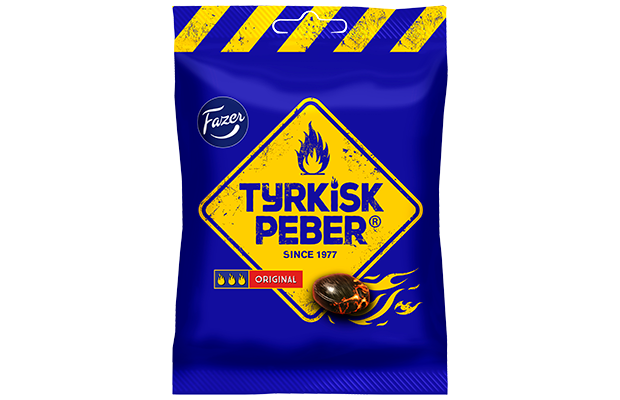 A blue bag of Fazer Tyrkisk Peber Original by Fazer, featuring a yellow diamond label with flames, the brand name, and a burning salty liquorice candy illustration. Bold yellow warning stripes accent the top.