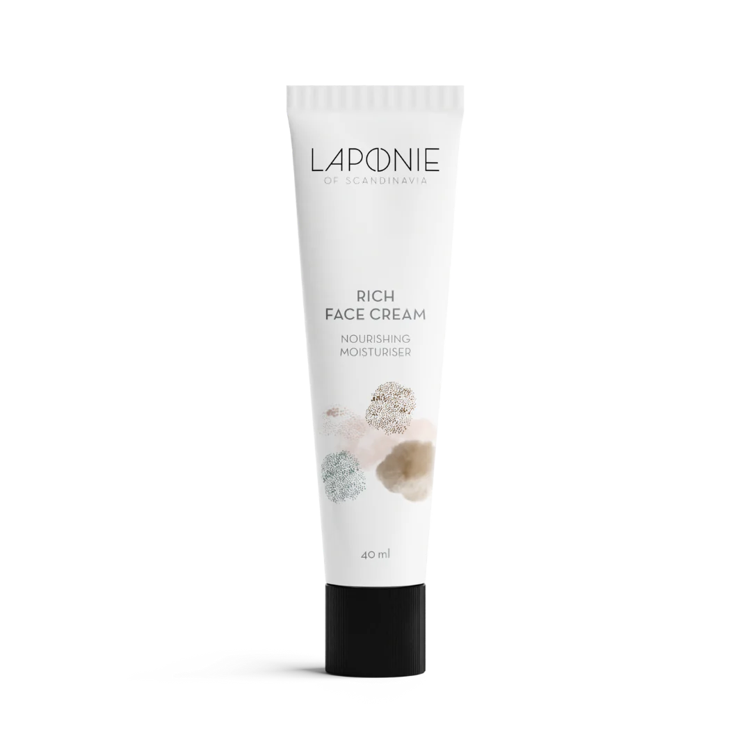 A white tube of Laponie of Scandinavia Rich Face Cream with a black cap, minimalist branding, and pastel abstract accents on the front. This fragrance-free moisturizer for dry skin is labeled Nourishing Moisturiser and comes in a 40 ml size.