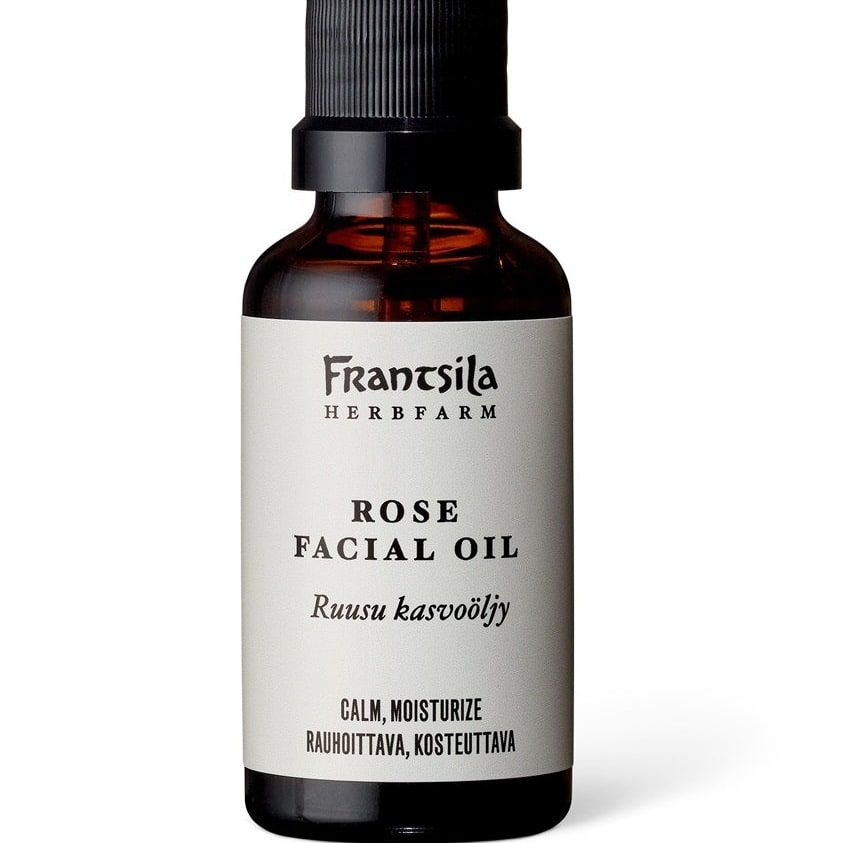 A brown bottle with a black pump labeled Frantsila Midsummer Rose Facial Oil features English and Finnish text about its calming, moisturizing benefits, and contains natural rosehip seed oil from Frantsila.
