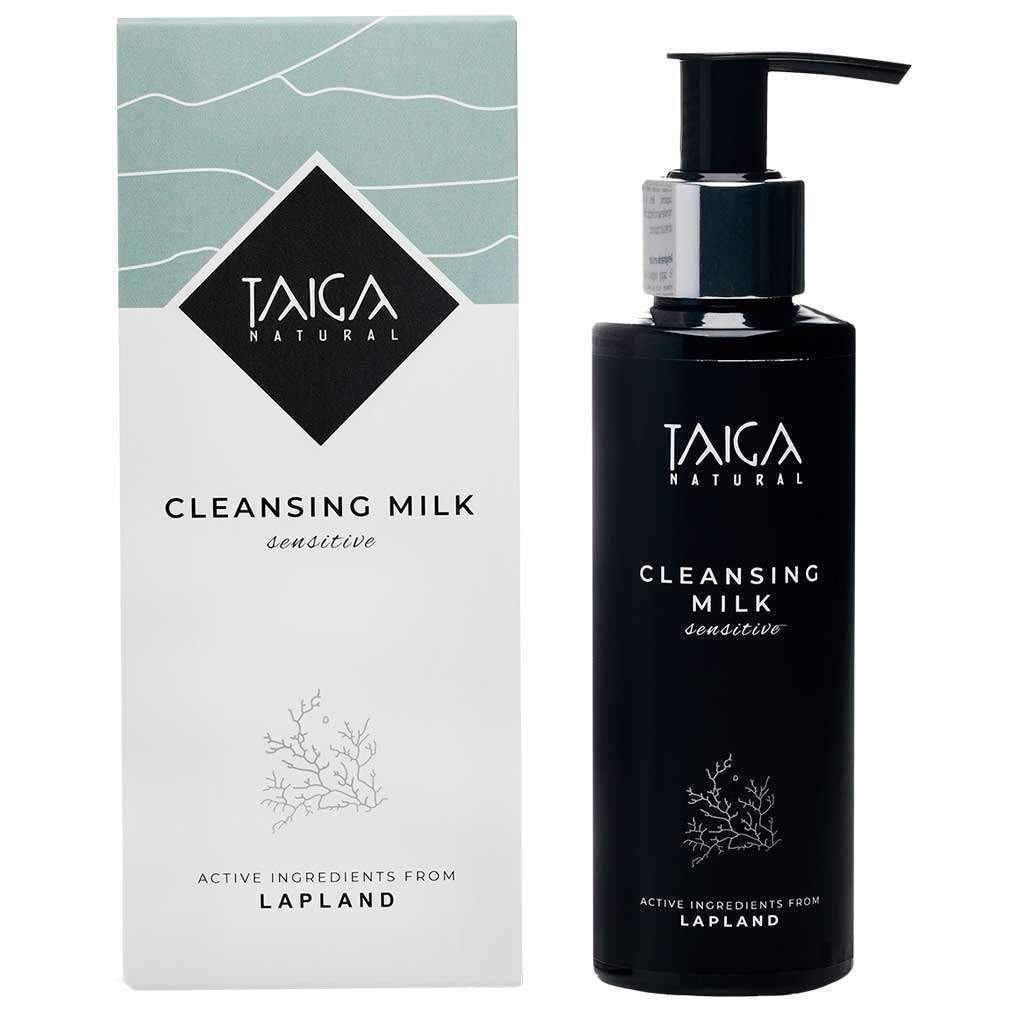A bottle of Taiga Cosmetics Cleansing Milk Sensitive stands beside its box. Both feature a minimalist black and white design, highlighting this gentle face cleanser by Taiga Cosmetics, made with natural ingredients from Lapland.