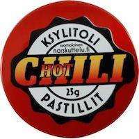 A round red tin labeled Narskuttelu Xylitol Pastilles Hot Chili hints at spicy chili-flavored xylitol candies by Narskuttelu, designed to help protect teeth from cavities.