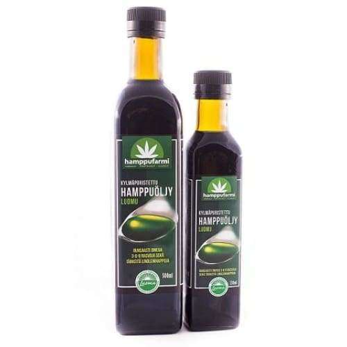 Two bottles of Nordic Hempfarm Organic Cold Pressed Hemp Oil, one large and one small, come in dark glass with green labels featuring a hemp leaf and Finnish text, rich in omega-3 fatty acids.