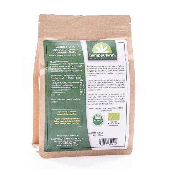 A brown paper pack of Nordic Hempfarm Organic Roasted and Salted Hemp Seed features a green and white label in Finnish, highlighting nutritional info, product details, and omega-3s from premium Finnish hemp.