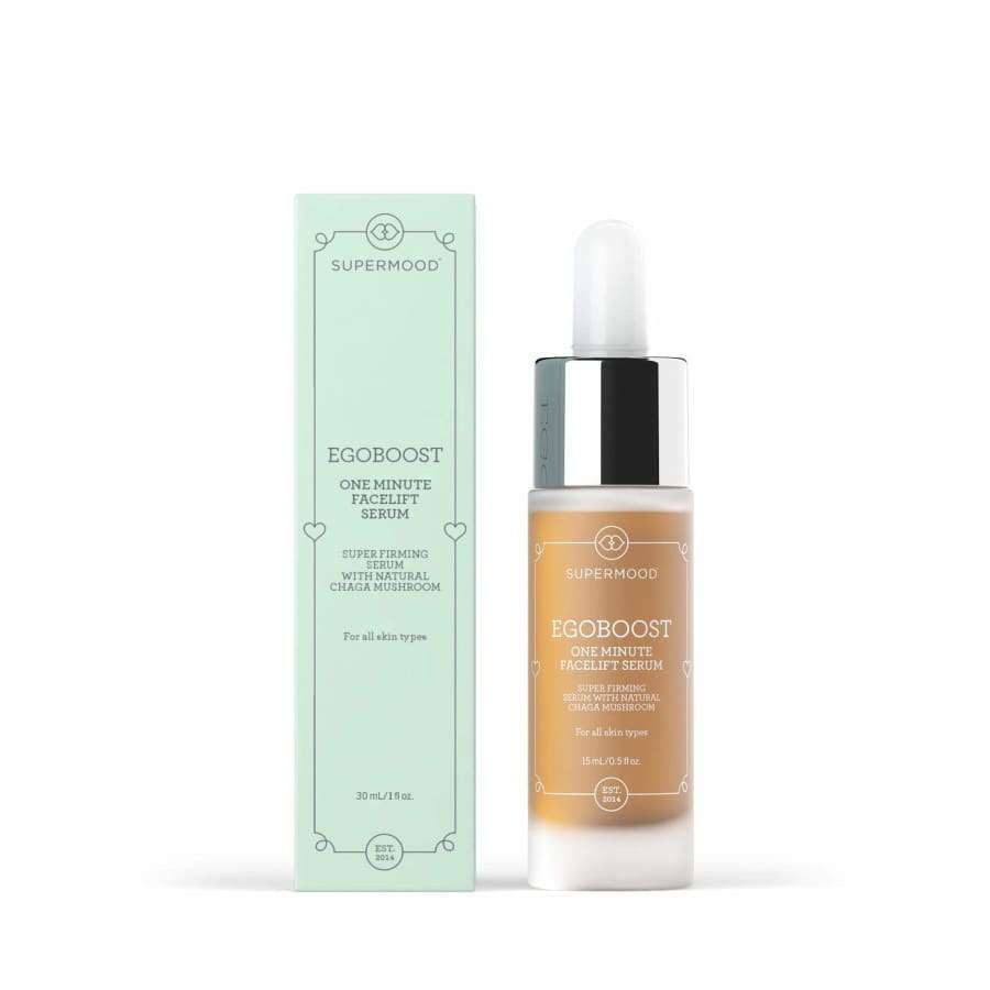A bottle of Supermood Egoboost One Minute Facelift Serum sits beside its mint green box. This tightening serum from Supermood delivers a fast facelift effect and suits all skin types, with details on both the label and packaging.