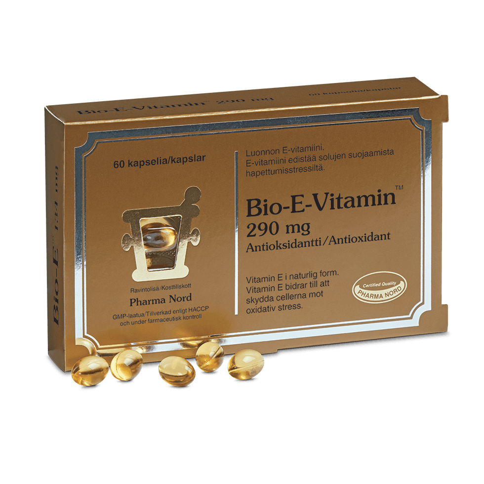 Abgebildet ist eine gold- und braunfarbene Schachtel mit der Aufschrift Pharma Nord Bio-E Vitamin 290 mg, vor der sich mehrere Weichgelatinekapseln befinden. Die Verpackung hebt natürliches Vitamin E und antioxidative Eigenschaften hervor und enthält Text in mehreren Sprachen.