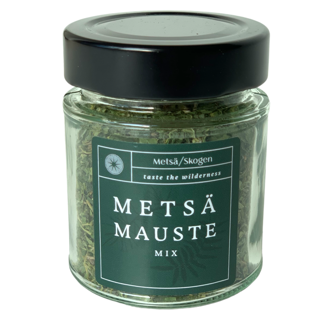 Ein Glasgefäß mit schwarzem Deckel enthält Metsä/Skogen Forest Seasoning Mix. Auf dem grünen Etikett ist die Marke Metsä/Skogen abgebildet und zu lesen: "Schmecken Sie die wilden Aromen des finnischen Waldes", mit dekorativen Elementen.