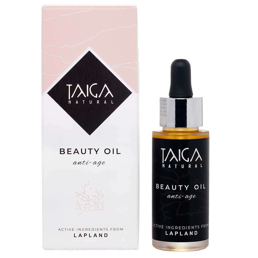 Ein Flakon von Taiga Cosmetics Beauty Oil Anti-Age mit einem Tropfverschluss steht neben der weiß-rosa Schachtel. Das Etikett hebt die Anti-Aging- und Wirkstoffe aus Lappland hervor, wie z. B. das Sanddornöl. Marke: Taiga Cosmetics.