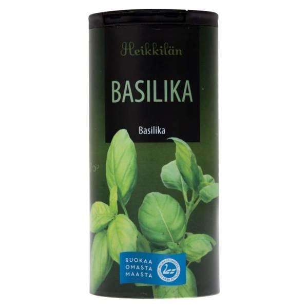 Ein grüner, zylindrischer Behälter mit Basilikum von Heikkilä's ist mit Basilikumblättern und finnischem Text versehen - ideal für ein klassisches Pasta-Kraut der Marke Heikkilä's.