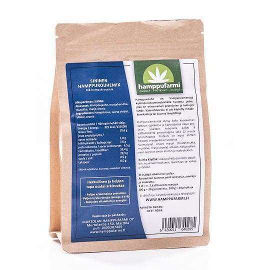 Die Verpackung von Nordic Hempfarm Blue Hemp Mix aus braunem Papier enthält auf der Rückseite detaillierte Produktinformationen und Nährwertangaben in finnischer Sprache. Hergestellt von Nordic Hempfarm aus finnischen Beeren und Hanfsamen, ist diese Mischung frei von Zuckerzusatz.