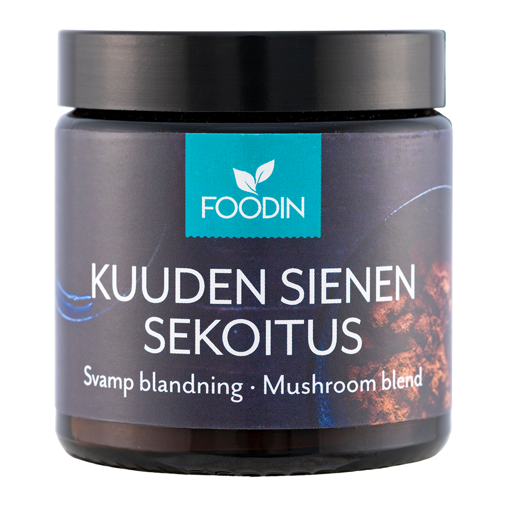 Un pot foncé portant la mention « Foodin Six Mushroom Mix » avec un logo bleu en forme de feuille sur le dessus et la sous-inscription blanche « Svamp blandning · Mushroom blend » ; ce complément alimentaire polyvalent à base de six champignons est fabriqué par Foodin.
