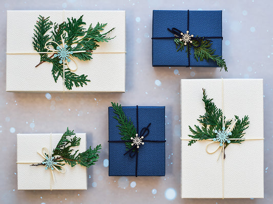 Blue and white Christmas gifts with spruce tree branches