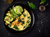 Ketogenic breakfast omelette with avocados, nuts, spinach and cucumber