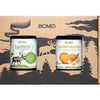 The Biomed Gift Set Bone Broth by Biomed includes two jars: one with reindeer bone broth and another with ginger & turmeric, both in a decorative forest-themed package.