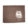 The Emendo Stinky Seat Cover by Emendo is a brown cloth napkin with a white illustration of Moomin Stinky—perfect as a unique linen sauna cover or seat cover.