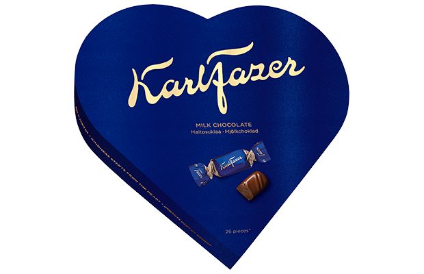 The Fazer Milk Chocolate Gift Box features a blue, heart-shaped box with gold lettering and images of wrapped and unwrapped milk chocolates on the front. This gift box from Fazer contains 26 milk chocolate pieces.