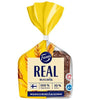 A loaf of Fazer Real Rye by Fazer in yellow and clear packaging displays dark, high-fiber bread. The label has wheat graphics, Finnish text, and symbols indicating 100% whole grain and 10% fiber content.