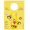 The Gustaf & Linnea Moomin Lipbalm Little My features eco-friendly yellow packaging with Little My among flowers. Handmade in Sweden, this organic, plastic-free balm uses ethically sourced beeswax for deep moisture.