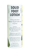 A cylindrical tube of Gustaf & Linnea Snufkins Solid Foot Lotion for dry heels, with product details, ingredients, and company contact info on the minimalist, eco-friendly label featuring botanical illustrations.