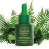 A green dropper bottle labeled Luonkos Eternity Facial Oil Serum rests among lush ferns. The text highlights its natural microbiome, Finnish forest microbe extract, and suitability for all skin types. Brand: Luonkos.