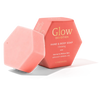 A pink hexagonal bar of Luonkos Glow Devotion Hand & Body Soap stands beside its matching box, featuring apricot kernel oil. This natural vegan soap is designed for normal to mature skin.