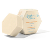 An off-white, hexagonal Luonkos Hydrate Essence Hand & Body Soap bar sits beside its box. Fragrance-free and made with natural plant oils, it's ideal for cleansing and caring for dry or sensitive skin.
