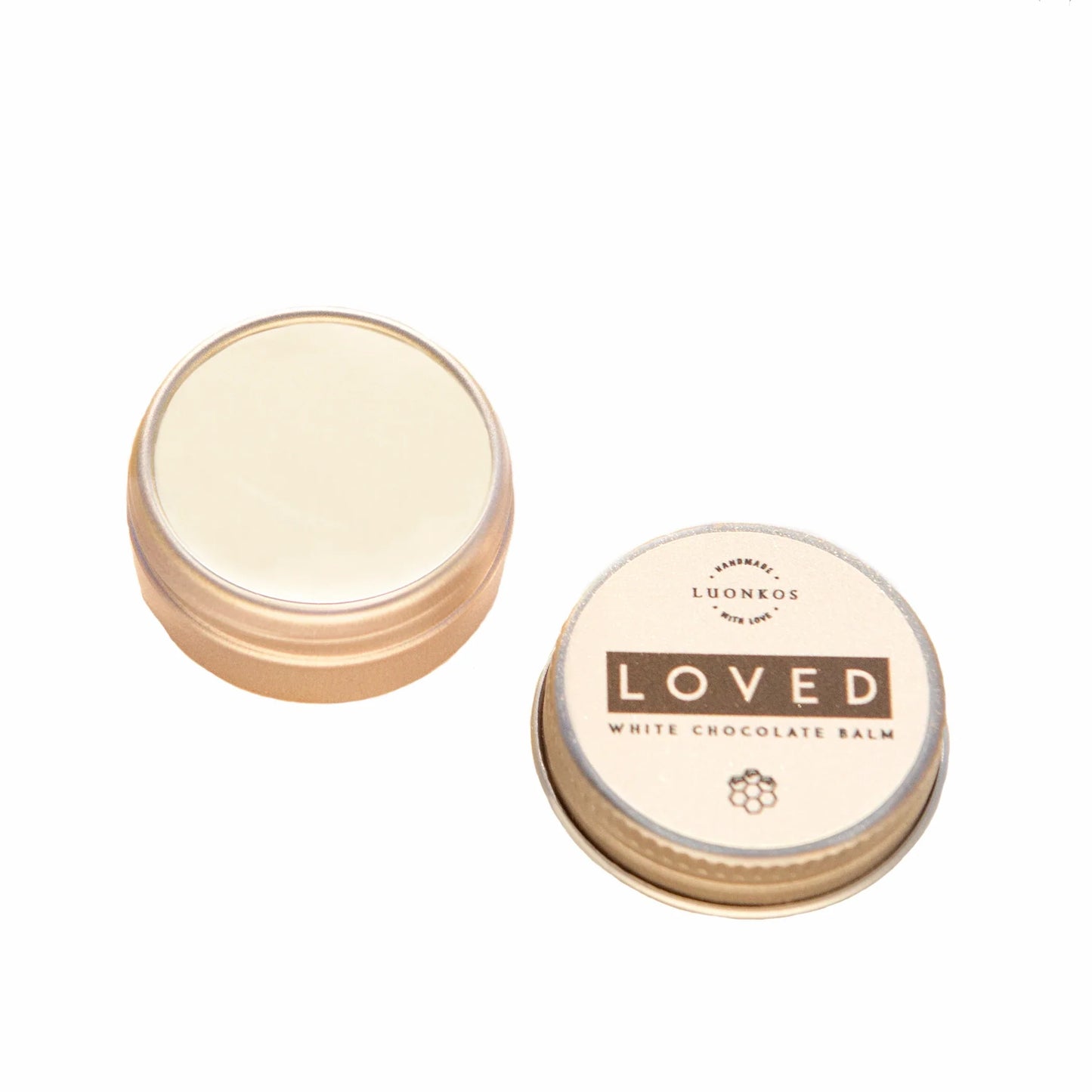 Two small round tins, one closed and one open to reveal a pale balm inside. The closed tin is labeled Luonkos Loved White Chocolate Multipurpose Lip Balm—a natural, handmade product from Finland with simple black and gold design.