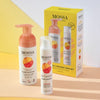 The Mossa Vitamin C Gift Set by Mossa features a cleansing foam and brightening moisturizer in fruit-themed yellow packaging, beautifully arranged on a pastel yellow and peach background.