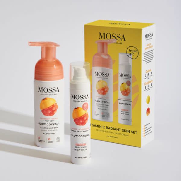 The Mossa Vitamin C Gift Set features two skincare products—a cleansing foam and a night cream—alongside its yellow box decorated with fruit illustrations and brightening benefits, by the brand Mossa.