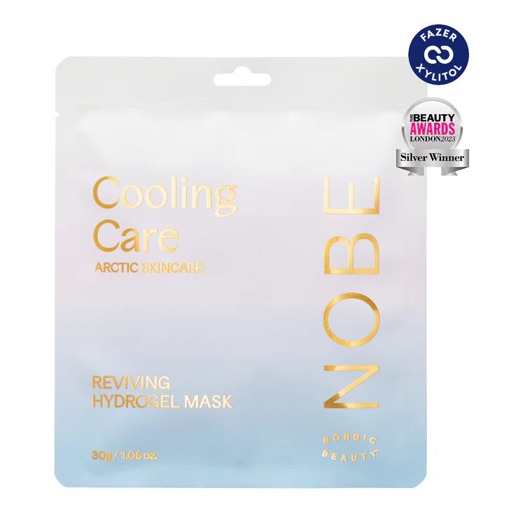 A pastel pouch labeled NOBE Nordic Cooling Skincare Rituals by NOBE Nordic Beauty features gold accents and a minimalist look. Silver and purple award badges top the design, perfect for any Nordic Skincare Gift Set or cooling skincare routine.