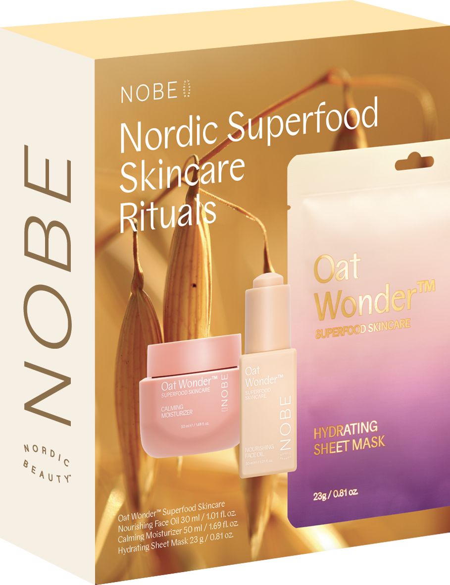 The NOBE Nordic Beauty NOBE Nordic Superfood Skincare Rituals gift set features Oat Wonder face oil, calming moisturizer, and hydrating sheet mask, all enriched with organic oat oil and pictured with Nordic oats in the background.