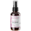 A 500 ml amber glass spray bottle of Puhdas+ Beauty Rose Water with a black pump and a white label featuring pink floral accents, set against a plain white background.