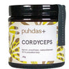 A jar of Puhdas+ Cordyceps supplement, featuring a black lid and base, a white label with brown and yellow patterns, and a black hanging tag on a white background.