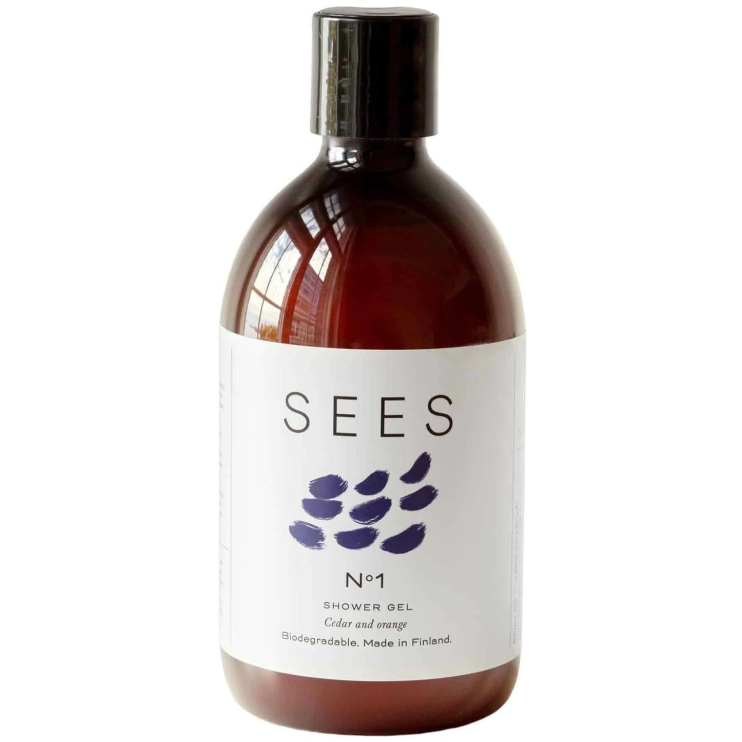 A brown bottle of SEES Company Body Wash, Cedar & Orange, with a white label featuring abstract purple brushstrokes. This biodegradable Nordic body wash is made in Finland.