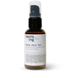 A brown bottle of sauna/ing Sauna Hair Oil with a black pump and white label, featuring Strengthening Golden Kelp & Nourishing Almond for heat protection and frizz control. The label lists ingredients, location coordinates, and the sauna/ing brand.