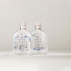Two clear SEES x Moomin Room Diffuser Nordic Winter bottles by SEES Company, with cork stoppers and delicate blue designs, evoke Finnish style against a plain light background.