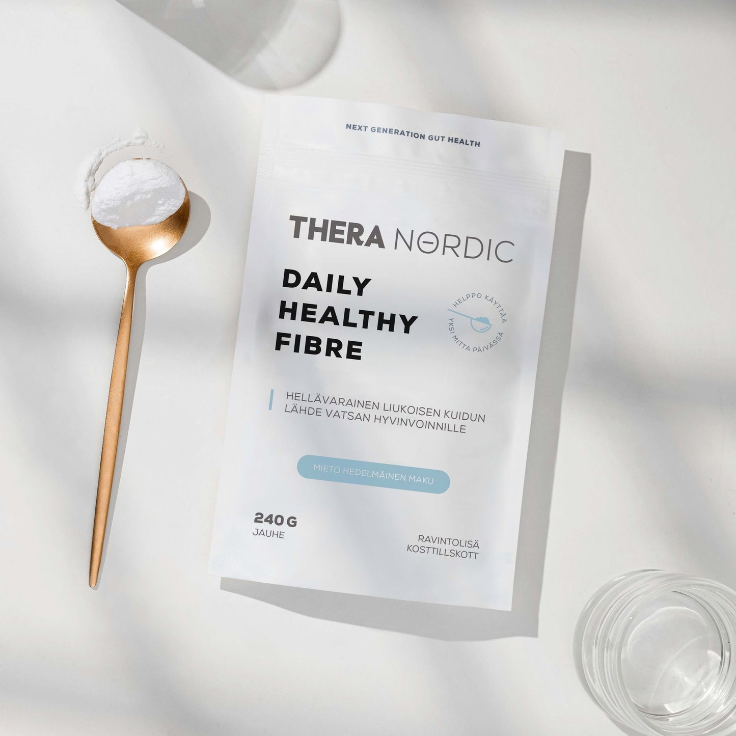 Thera Nordic Daily Healthy Fibre package with a spoonful of powder and glasses on a light background