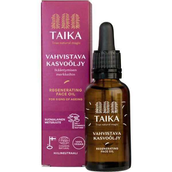 A brown glass dropper bottle labeled Taika Regenerating Face Oil by Taika is displayed before a matching pink box with Finnish and English text, promoting its vegan, natural, anti-aging formula with Finnish forest microbe extract.