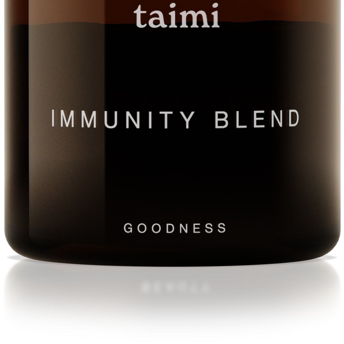 A brown glass jar with a black lid features the Taimi brand on top, "Taimi Immunity Blend" in the center, and "Goodness" at the bottom. The minimalist label highlights this vegan immune support formula made with adaptogenic herbs.