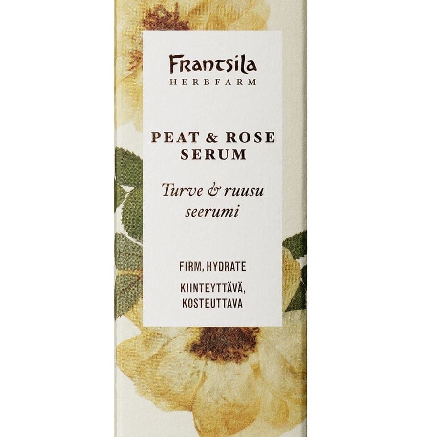 A rectangular box of Frantsila Midsummer Rose & Peat Serum features yellow floral designs and bilingual English-Finnish text, highlighting its firming, hydrating benefits and natural ingredients like rosehip seed oil.