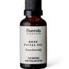A brown bottle with a black pump labeled Frantsila Midsummer Rose Facial Oil features English and Finnish text about its calming, moisturizing benefits, and contains natural rosehip seed oil from Frantsila.