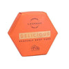 Hexagonal orange package labeled Luonkos Delicious Body Cake—this natural body moisturizer by Luonkos features a floral illustration and is enriched with essential oils for nourishing skincare.