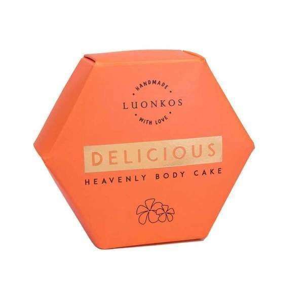 Hexagonal orange package labeled Luonkos Delicious Body Cake—this natural body moisturizer by Luonkos features a floral illustration and is enriched with essential oils for nourishing skincare.