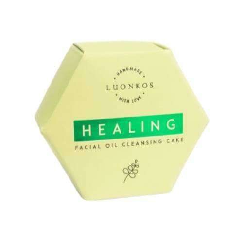 A hexagonal yellow box labeled Luonkos Healing Oil Cleansing Cake, a gentle handmade facial cleanser for oily skin by Luonkos, featuring a small leaf illustration and made with natural ingredients.