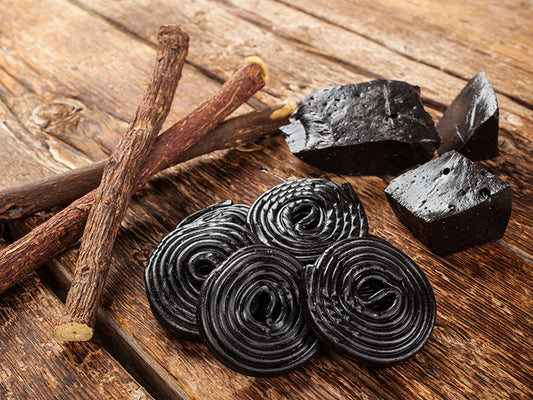 Licorice, salty licorice and licorice root on a wooden table