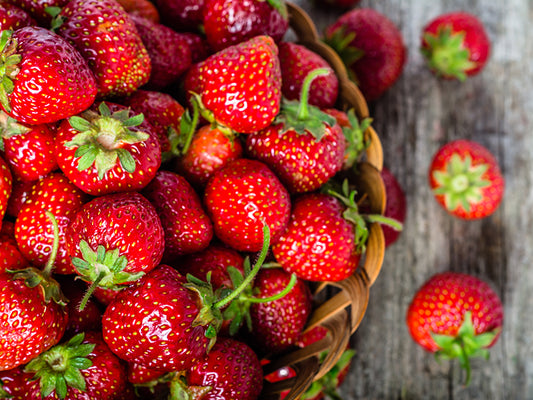 Strawberries in a basket on a wooden table