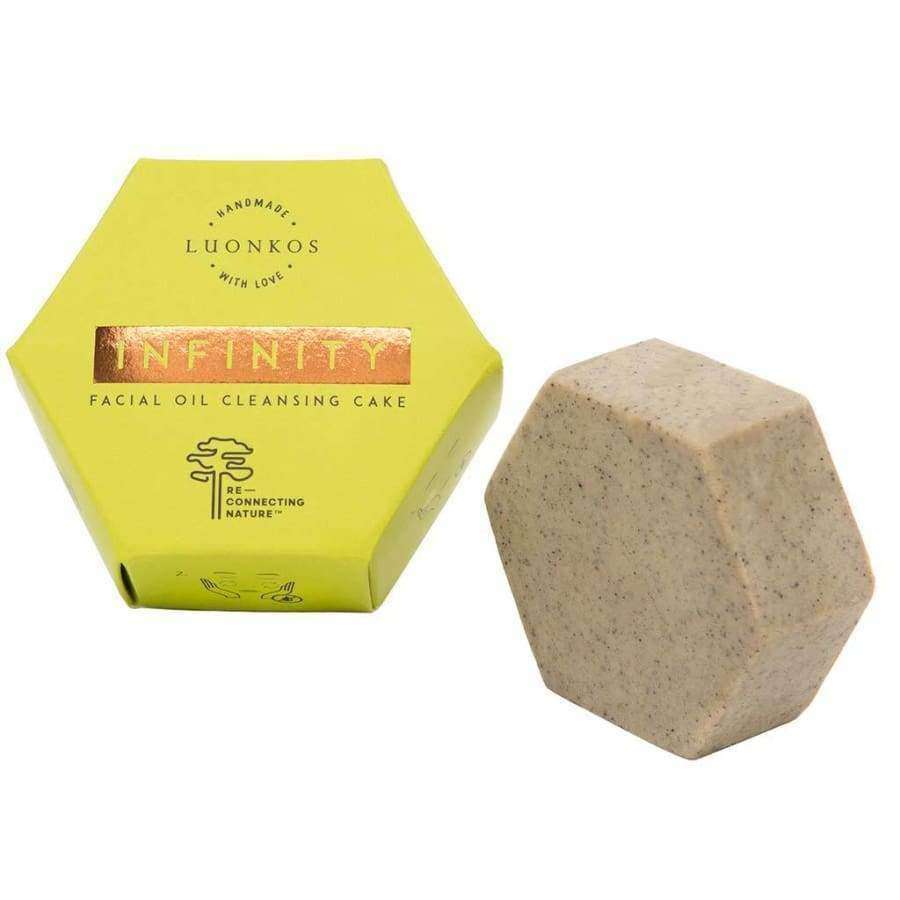 Ein sechseckiger Luonkos Infinity Oil Cleansing Cake ruht neben seiner passenden gelben Box und ist ideal für empfindliche Haut.