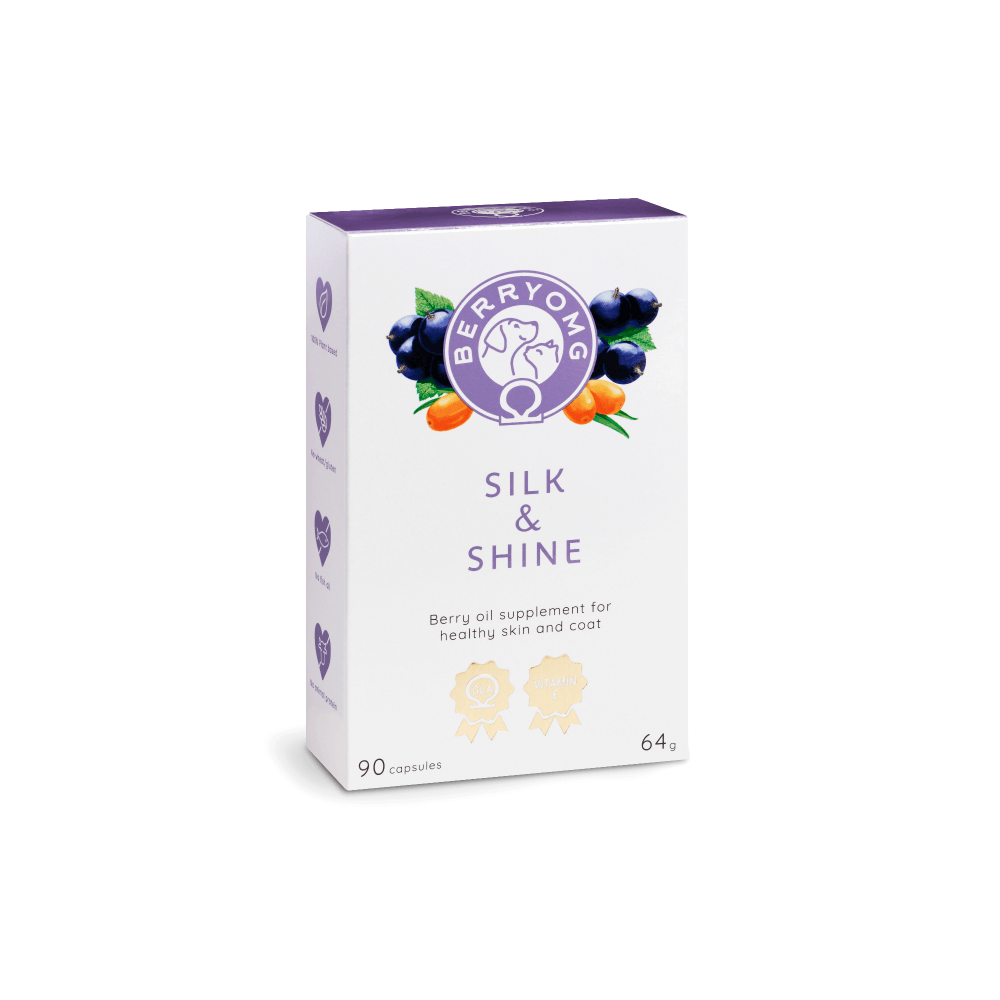 Boîte blanche et violette portant la mention « Berry OMG & Shine », complément alimentaire à base d'huile de baies et d'acides gras oméga pour la santé de la peau et du pelage, avec des images de baies et la mention « 90 capsules (64 g) » sur le devant.