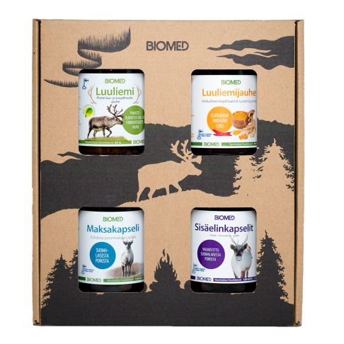 Le coffret cadeau Biomed Reindeer de Biomed comprend quatre pots : bouillon d'os de renne, bouillon d'os en poudre, gélules de foie et gélules d'abats. Le coffret est orné d'un motif forestier noir représentant des arbres et la silhouette d'un renne.