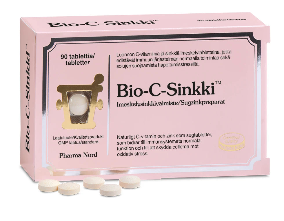 Una confezione rosa di compresse Bio-C-Zinc di Pharma Nord, che rafforzano il sistema immunitario, con diverse compresse rotonde in primo piano. La confezione riporta scritte in finlandese e svedese.